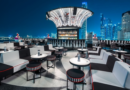 Luxury rooftop restaurant in Dubai decorated for Eid celebrations with skyline views, elegant dining setup, lantern lighting, and festive atmosphere